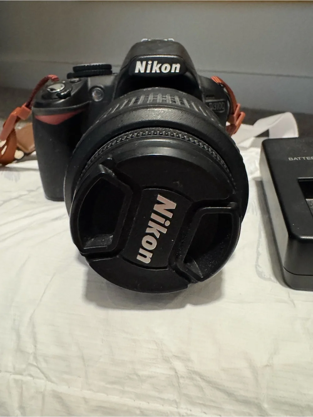 Nikon DSLR Camera with Black Lens and Black Charger